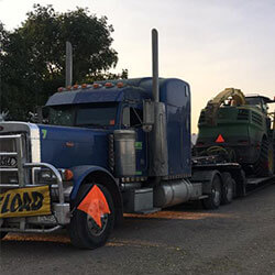 Forage Choppers loadded on a flat bed semi trailer | Trucking