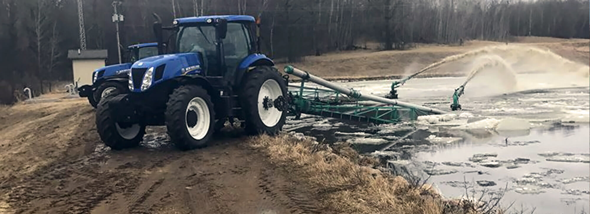 Tractor running a manure lagoon pumper